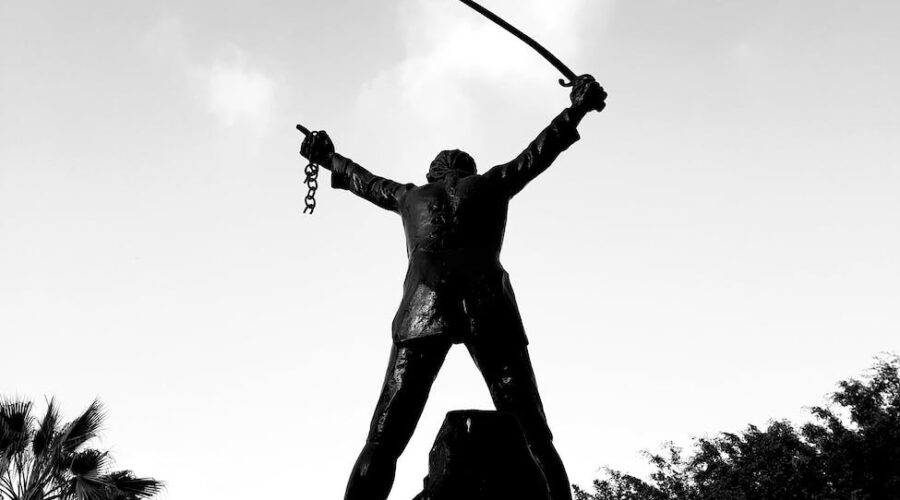 silhouette of man holing sword